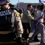 Rev Michael Woolf among 21 arrested at ICE protest 1
